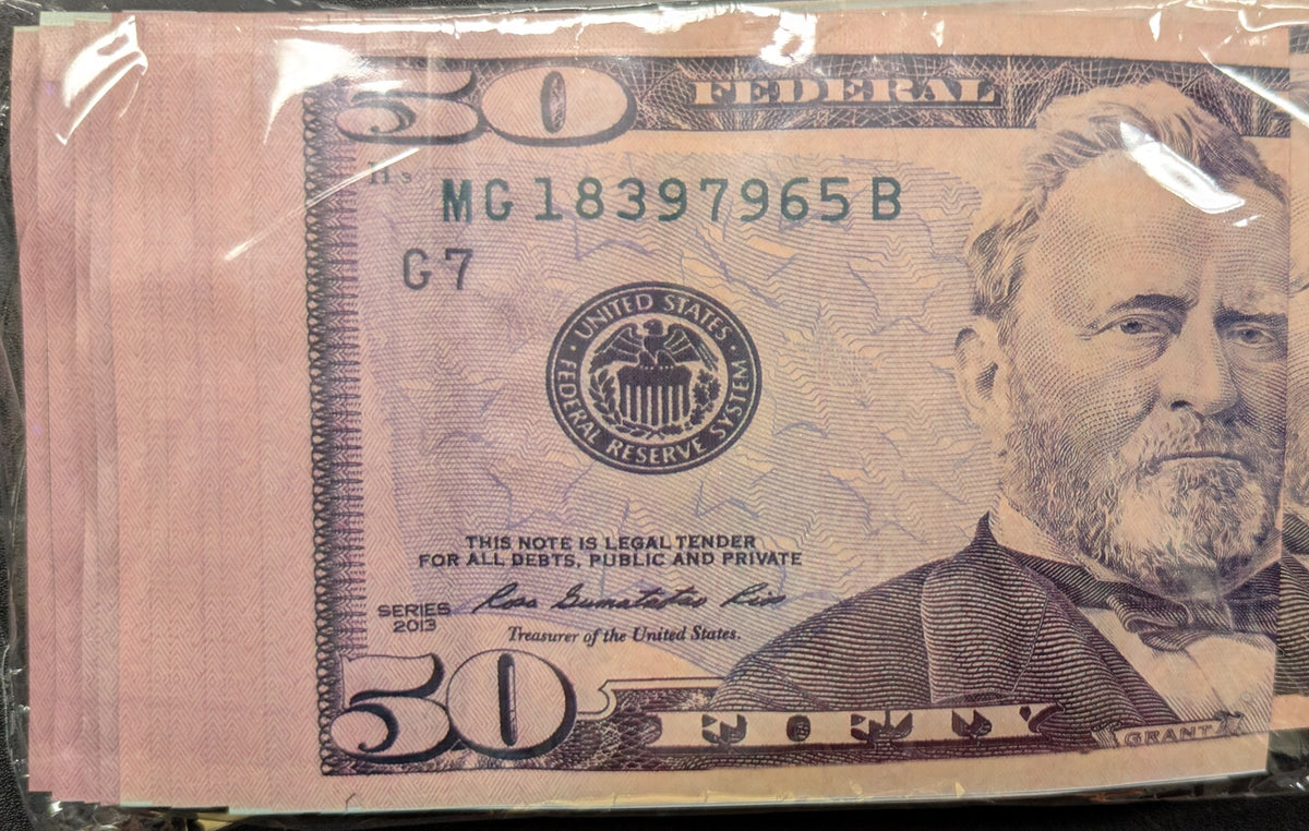Pink $50 dollar bill-shaped smell-proof bag from The Baggie Store, showing the detailed design and zipper closure.