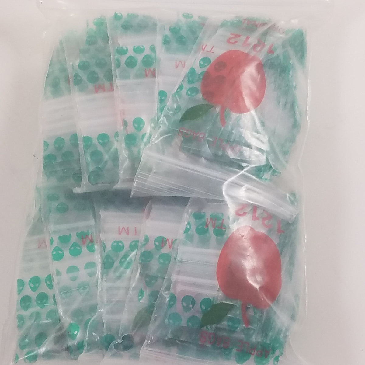 Resealable 1212 Original Apple Bags in alien design, 1/2 inch by 1/2 inch, made by Original Apple Bags for storage and packaging.