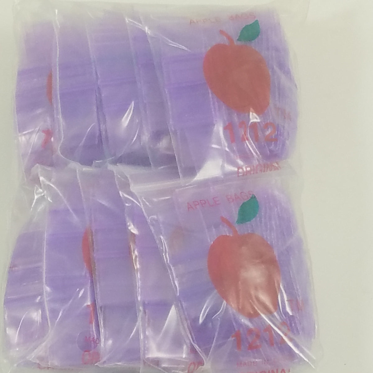 Purple 1212 Original Apple Bags resealable bags, 1/2" x 1/2", used for packaging small items or candies.