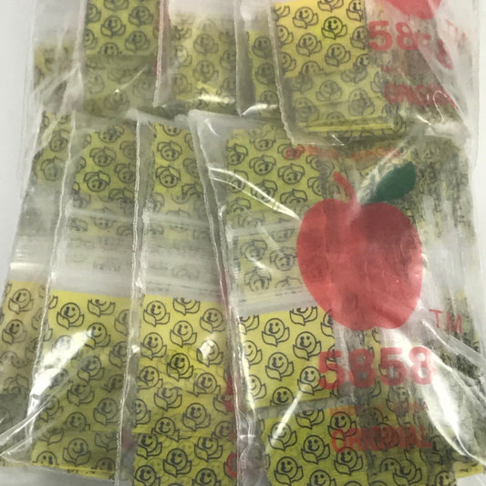 Original Apple Bags resealable bags with a happy face design, measuring 5/8" x 5/8", perfect for packaging small items.