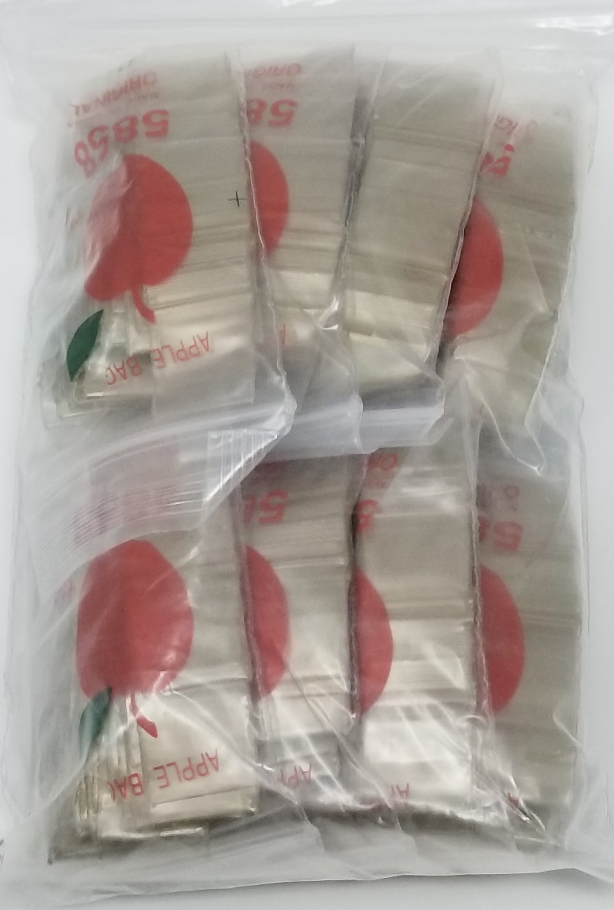 Resealable gold apple-shaped bags with 5/8 inch size, from Original Apple Bags, perfect for packaging small items.
