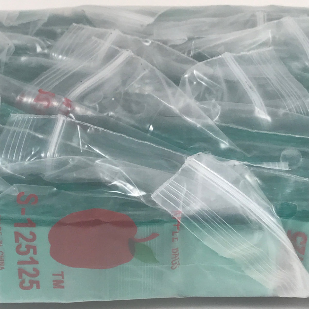 Green resealable bags from Original Apple Bags, 1.25 x 1.25 inches, perfect for storing small items or snacks.