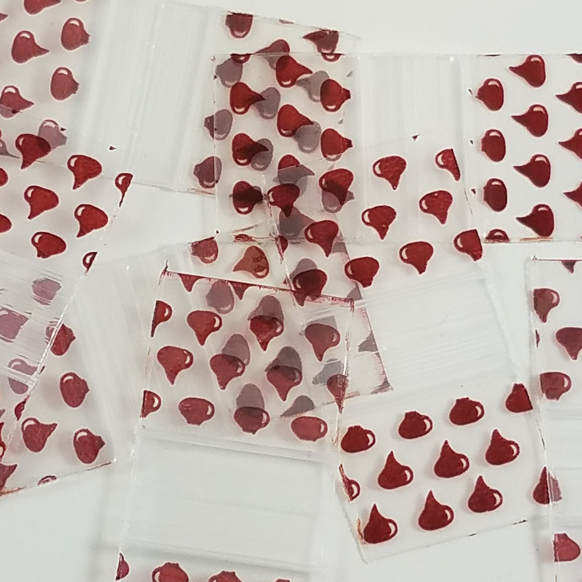 Chocolate Kiss shaped chocolate candies in 5858 Original Apple Bags, 5/8 inch by 5/8 inch, with shiny foil wrapping.