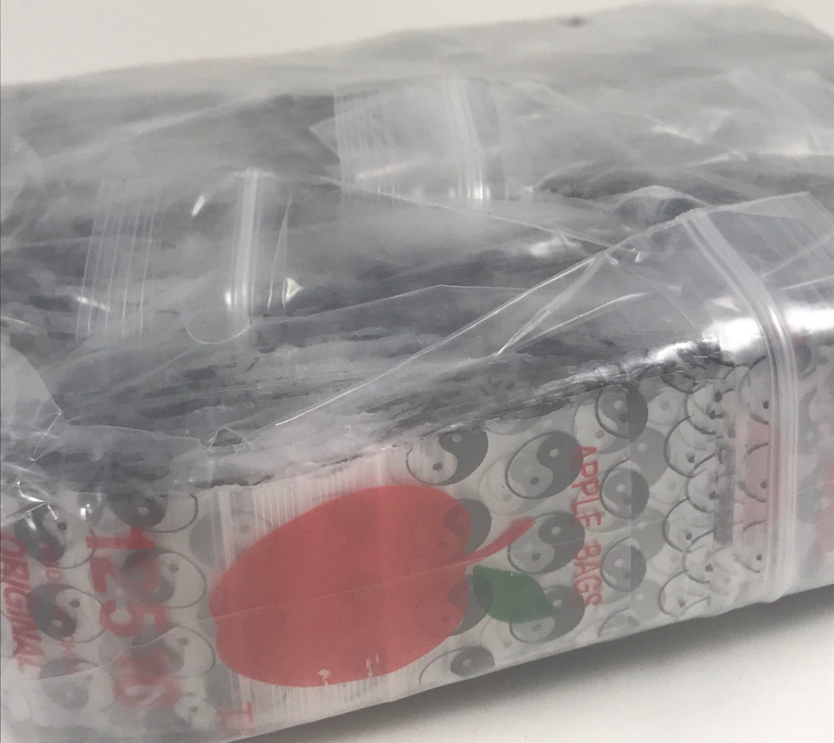 Original Apple Bags resealable bags with TaiJi/Yin Yang design, measuring 1.25" x 1" for packaging or storage.