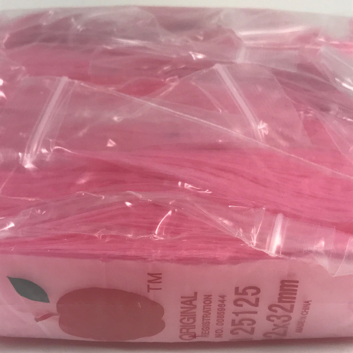 Pink resealable bags from Original Apple Bags, 1.25 x 1.25 inches, ideal for packaging small items or gifts.