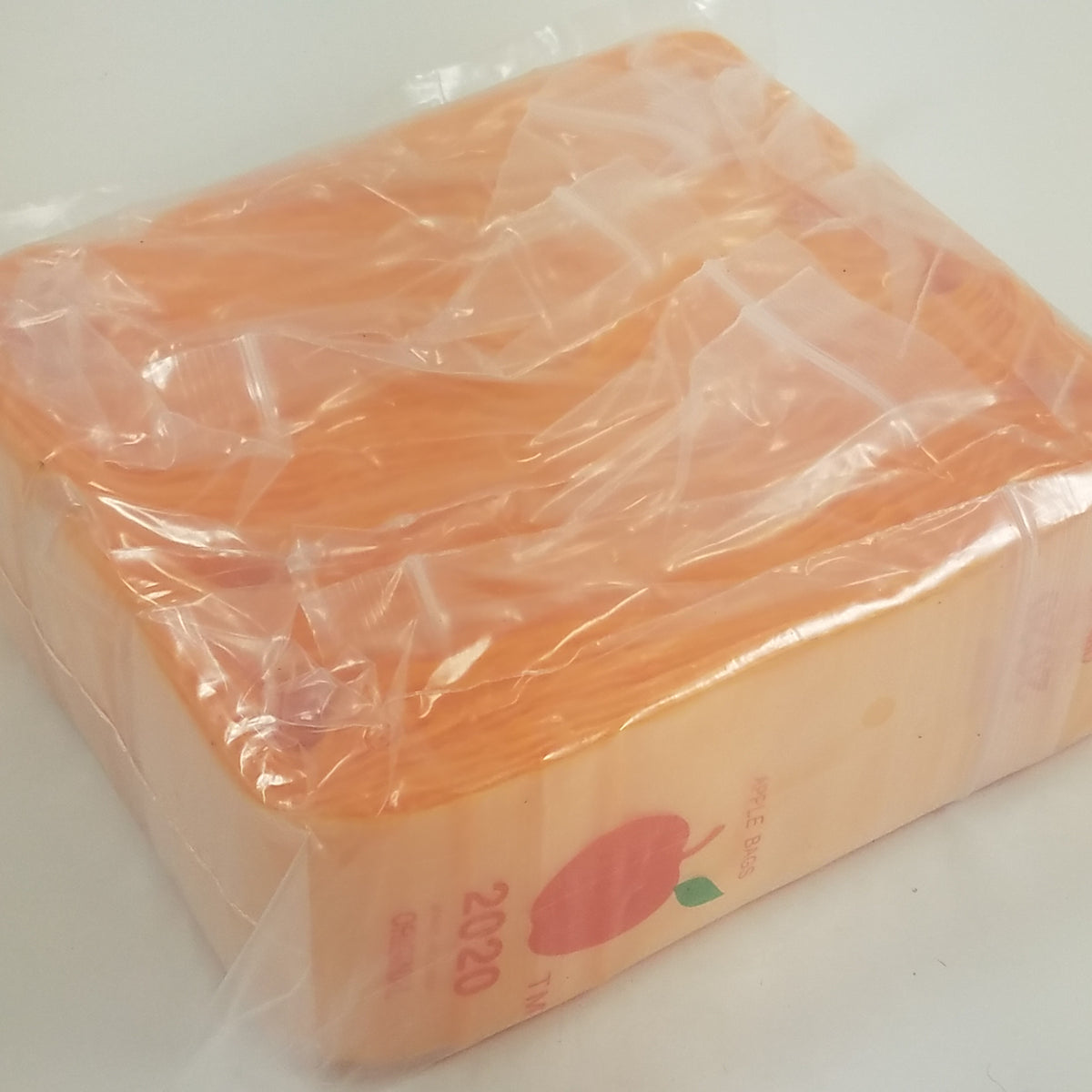 Orange 2x2-inch resealable bags by Original Apple Bags, perfect for storing small items or snacks.
