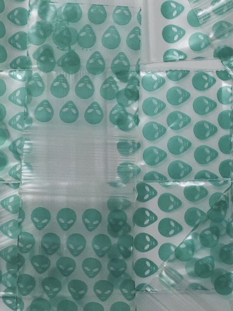 Green Alien resealable bags by Original Apple Bags, 1.5"x1.75" size, featuring a playful alien design on transparent storage bags.