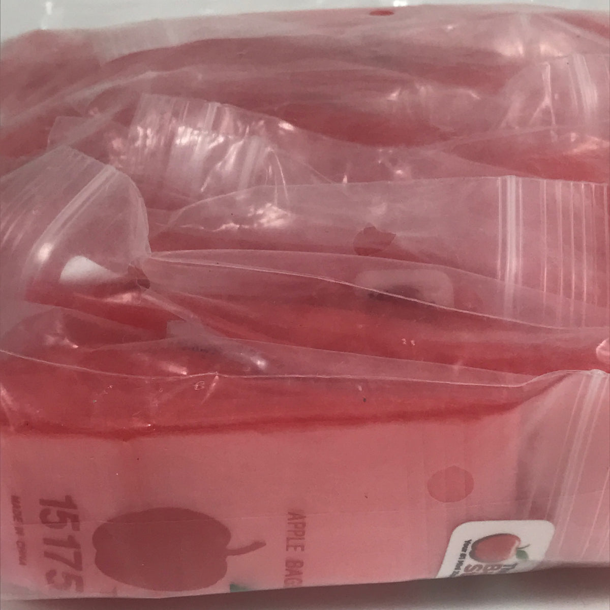 Red resealable Apple Bags by Original Apple Bags, 1.5 x 1.75 inches, ideal for packaging small items.