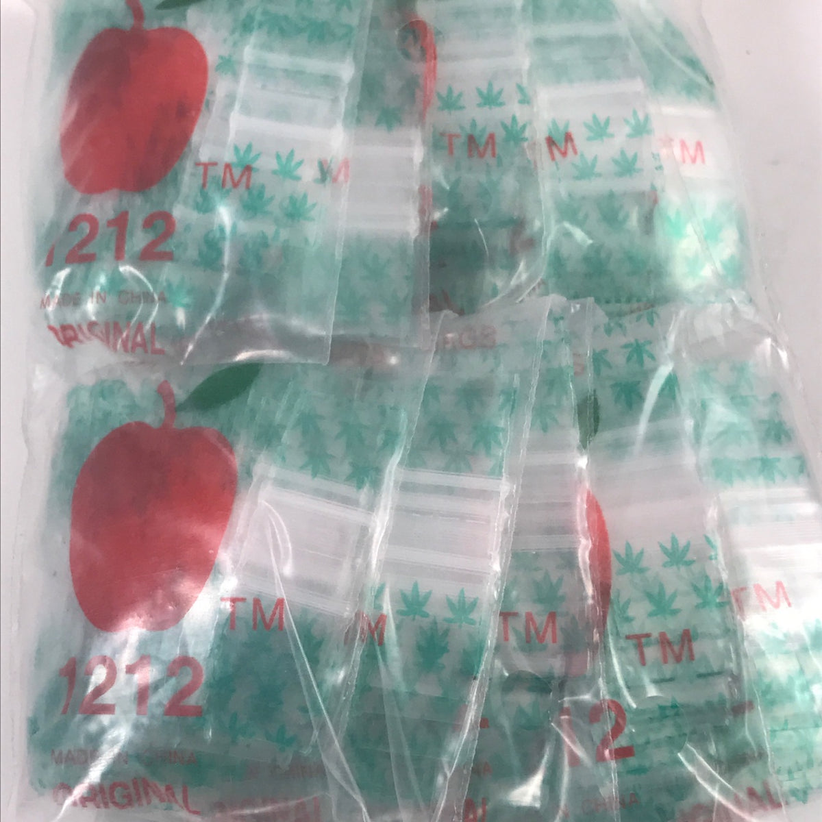 Resealable 1212 Original Apple Bags 1/2" x 1/2" with leaf design, ideal for storing small items or snacks.