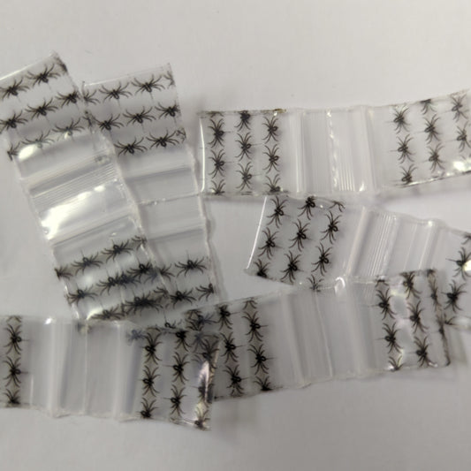 Black spider design resealable bags from Original Apple Bags, 5/8 inch by 5/8 inch, ideal for storing small items.