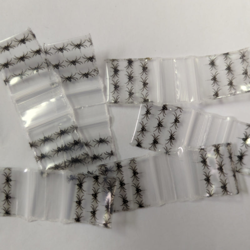 Black spider design resealable bags from Original Apple Bags, 5/8 inch by 5/8 inch, ideal for storing small items.