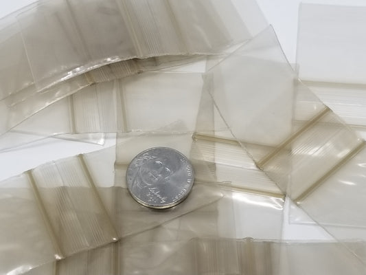 Gold resealable bags from Original Apple Bags, 1.25 x 1.25 inches, ideal for packaging small items or gifts.