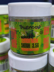 Indoor flower THC-A by Truemoola Premium, 3.5g, with vibrant green buds and orange hairs, packaged in a clear container.