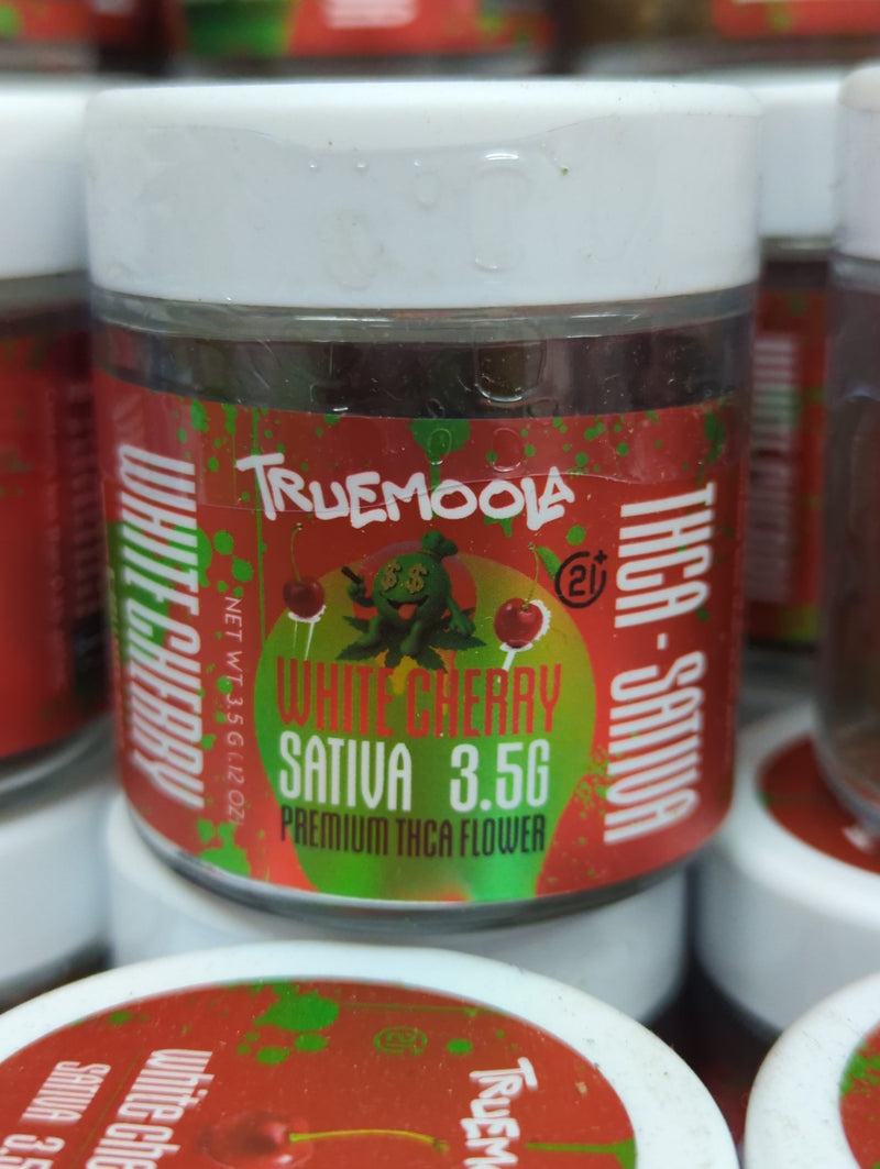 Premium indoor THC-A flower by The Baggie Store, showcasing fresh, lush green buds in a clear container.