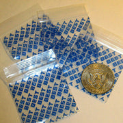Two 2x2 inch Original Apple Bags with rare designs, showcasing unique patterns and vibrant colors on smooth paper material.