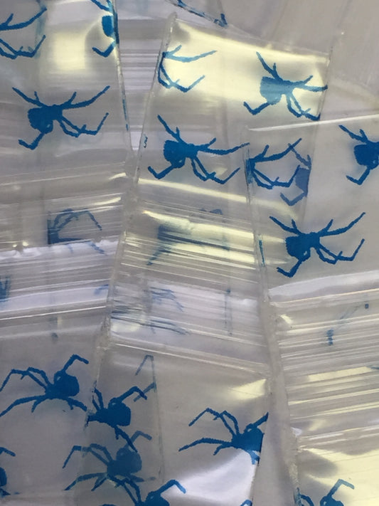 Black 1/2" x 1/2" resealable bags with spider design from Original Apple Bags, ideal for packaging and storage.
