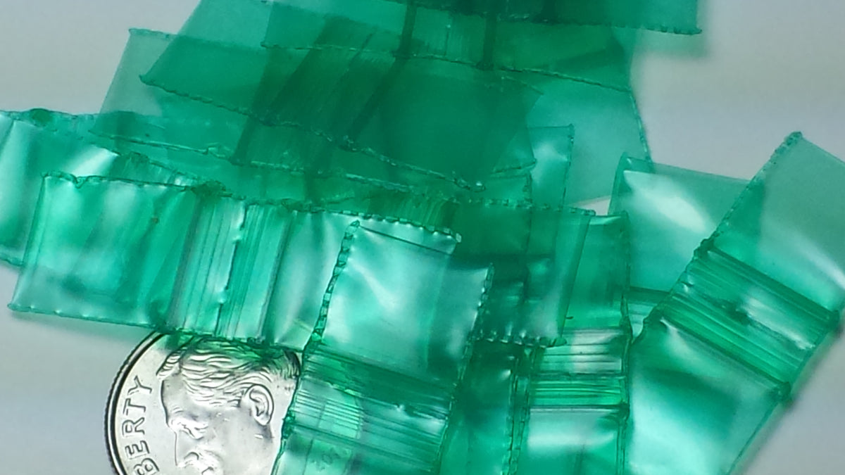 Green 3/8 inch by 3/8 inch resealable Original Apple Bags, small transparent plastic bags for storage or packaging.