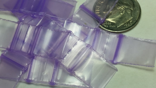 Purple resealable bags from Original Apple Bags, 1/2 inch by 1/2 inch, designed for secure storage and organization.