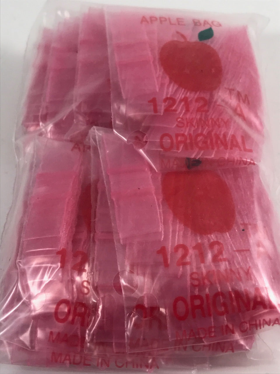 Pink 1/2" x 1/2" resealable bags from Original Apple Bags, ideal for packaging small items.