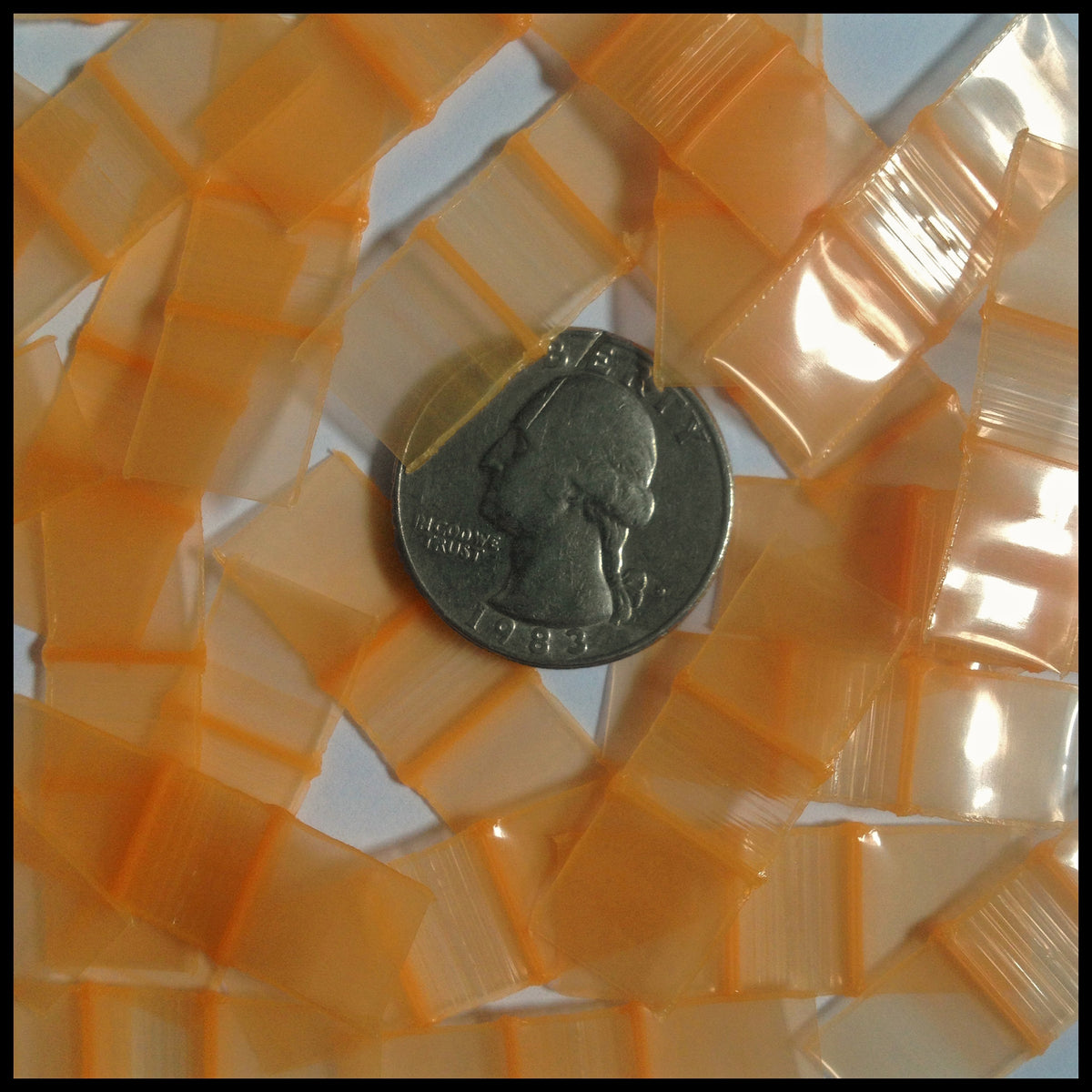 Resealable orange apple bags by Original Apple Bags, 1/2 inch by 1/2 inch, designed for secure storage and packaging.