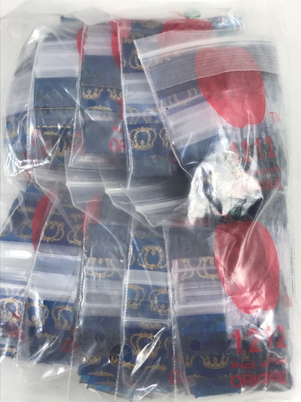 Resealable 1/2" x 1/2" original Apple Bags by KING CROWN, showing clear plastic bags with resealable closure and product branding.