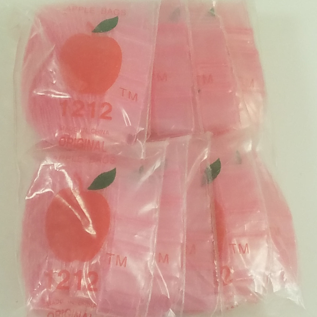 Pink 1/2" x 1/2" resealable bags from Original Apple Bags, perfect for packaging small items.