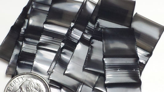 Black 1/2 inch by 1/2 inch resealable bags from Original Apple Bags, shown with clear material and sealing closure.
