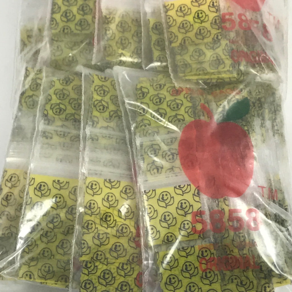 Original Apple Bags resealable bags with a happy face design, measuring 5/8" x 5/8", perfect for packaging small items.