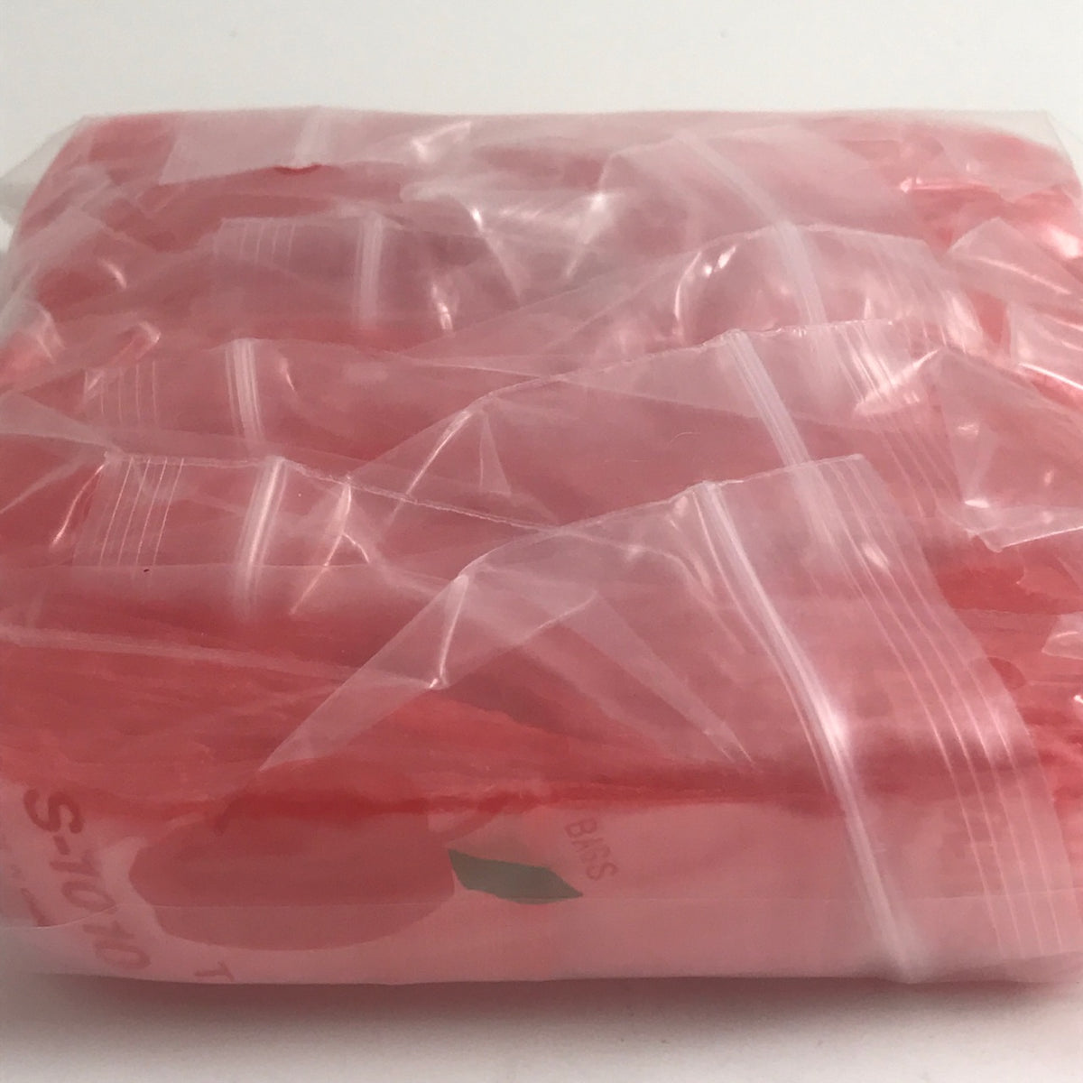 Red 1x1 inch resealable bags from Original Apple Bags, ideal for packaging and storage.