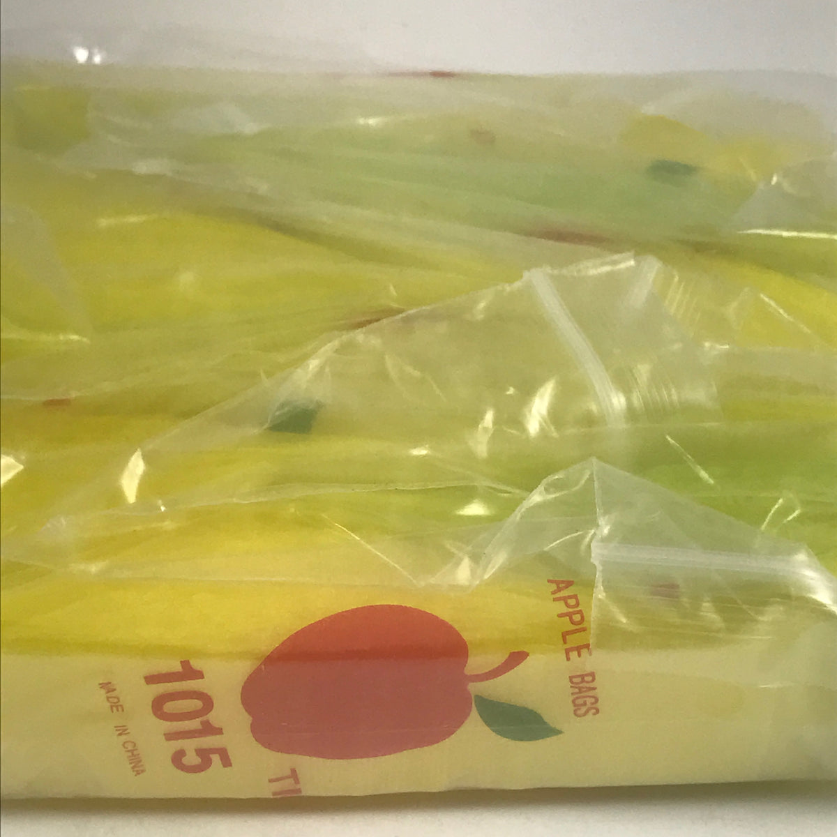 Yellow 1x1.5-inch resealable apple bags by Original Apple Bags, small and resealable packaging for produce storage.