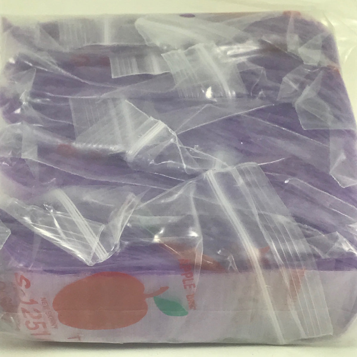 Purple resealable apple bags by Original Apple Bags, 1.25" x 1", designed for secure fruit storage.