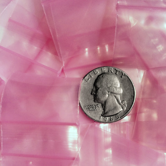 Pink resealable bags from Original Apple Bags, 1.25" x 1", designed for storing small items or packaging.