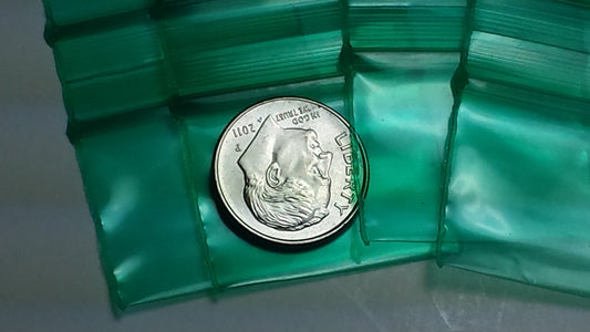 Green resealable Apple Bags by Original Apple Bags, 1.25" x 1", designed for storing small items and snacks.
