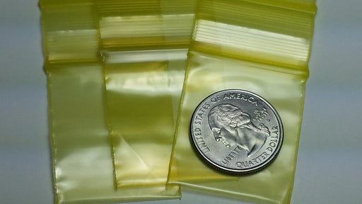 Original Apple Bags resealable yellow bags, 1.25" x 1.5", ideal for packaging small items and snacks.