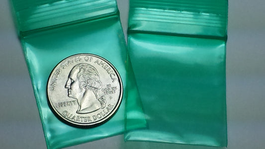 Green Original Apple Bags resealable bags, 1.25 x 1.5 inches, with a clear view of the green packaging and seal closure.