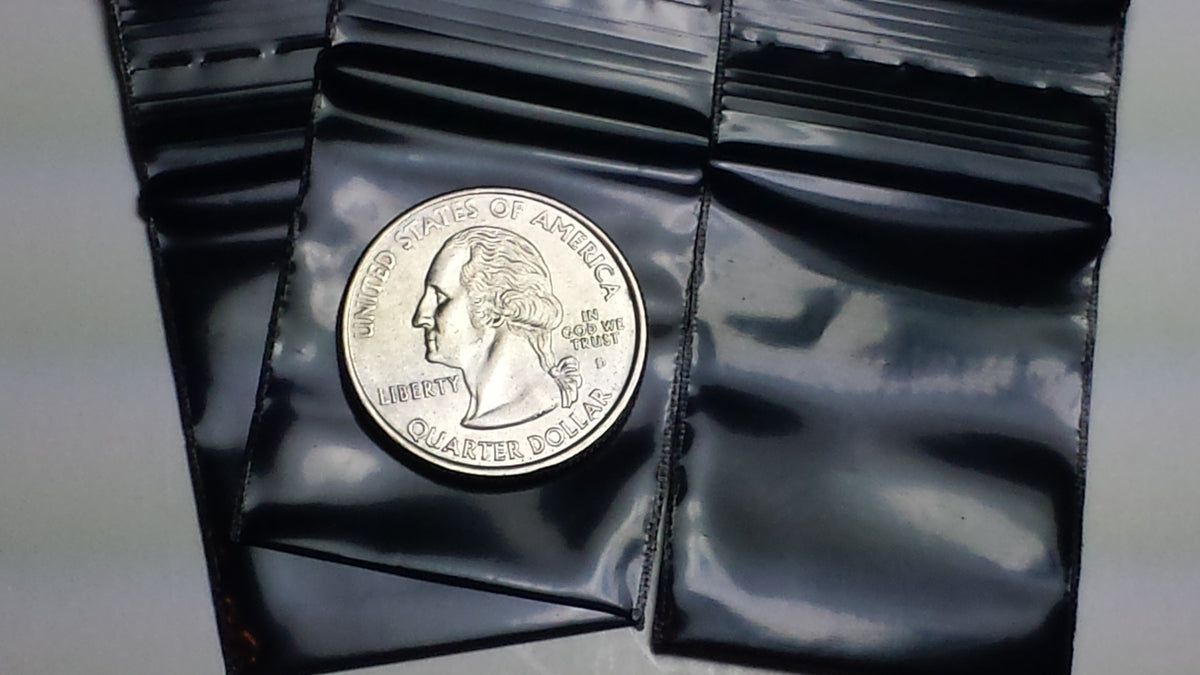 Black resealable bags by Original Apple Bags, measuring 1.25 x 1.5 inches, perfect for secure storage or packaging.