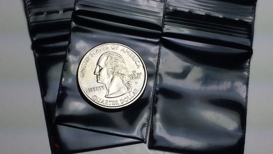 Black resealable bags by Original Apple Bags, measuring 1.25 x 1.5 inches, perfect for secure storage or packaging.