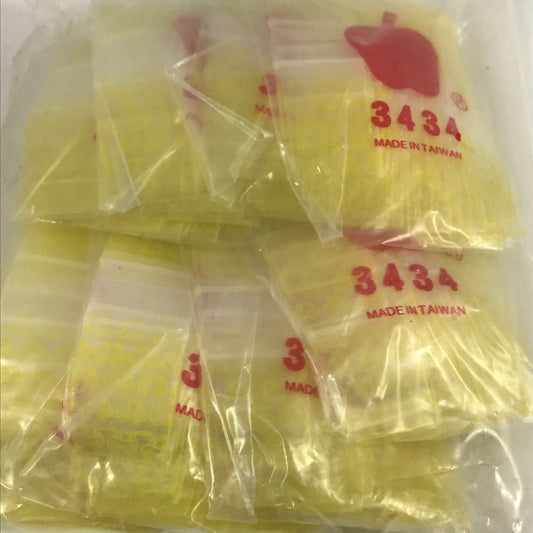 Original Apple Bags resealable bags, 3/4" x 3/4" size, designed for storing small items, in a bright taxi cab yellow color.