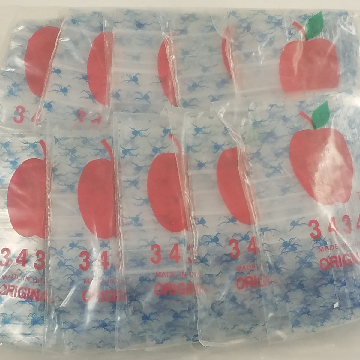 Resealable Apple Bags by Original Apple Bags, 3/4" x 3/4" smoke and fly design, suitable for storing small items or snacks.