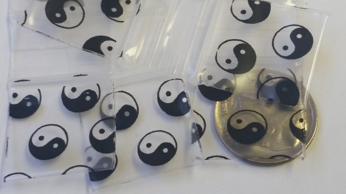 Original Apple Bags resealable bags with TaiJi/Yin Yang design, 3/4 inch by 3/4 inch, suitable for storing small items.