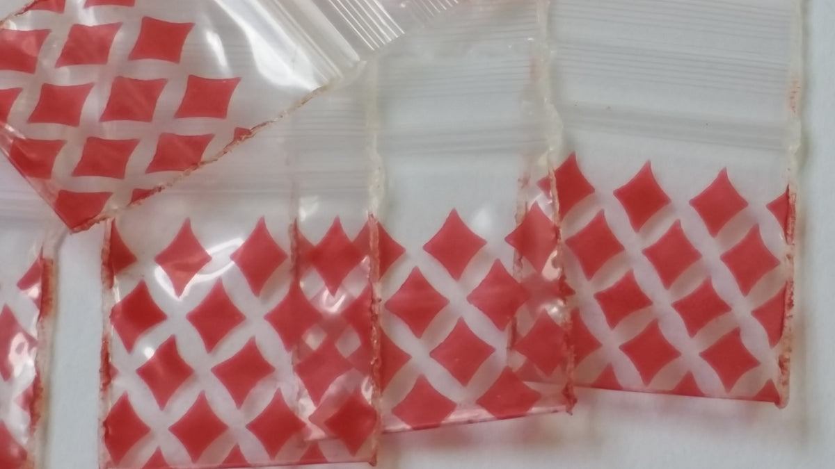 Red diamond resealable bags from Original Apple Bags, 3/4 inch by 3/4 inch, suitable for storing small items or collectibles.