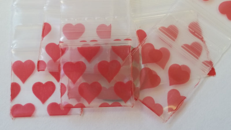 Original Apple Bags resealable bags with heart pattern, 3/4" x 3/4" size, ideal for storing small items or packaging.