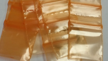 Orange Original Apple Bags resealable bags, 3/4" x 3/4", shown in a clear image with a focus on the vibrant color and compact size.