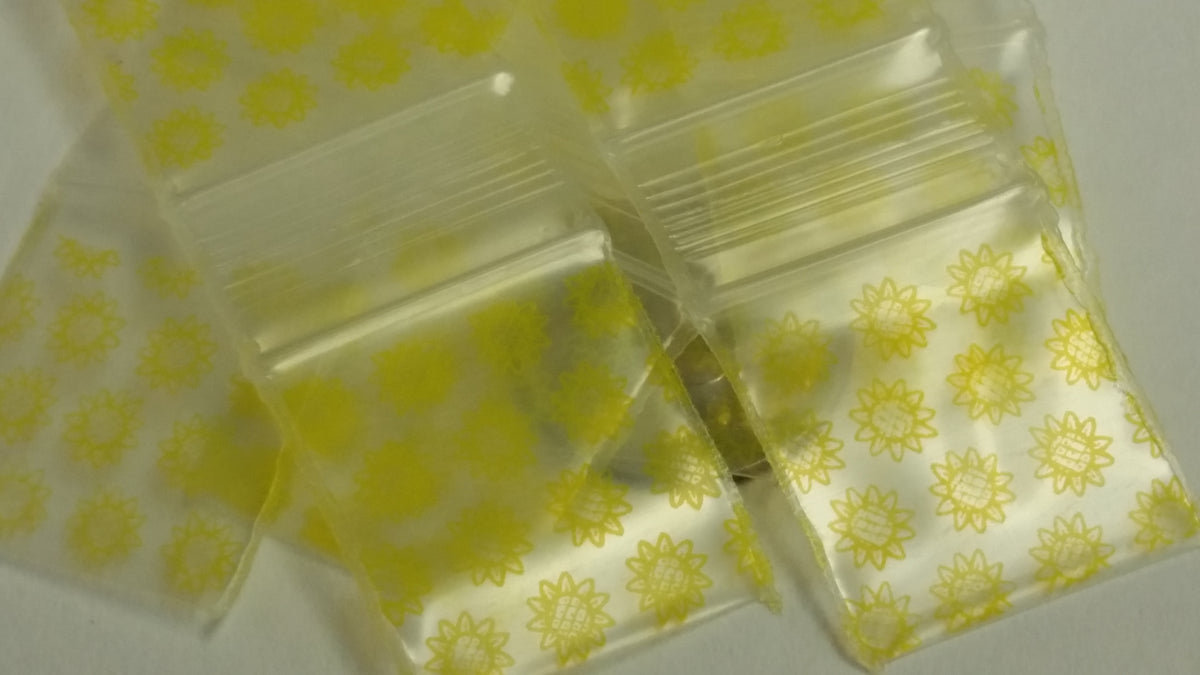 Original Apple Bags resealable 3/4" x 3/4" sunflower-themed bags for storing small items or treats.