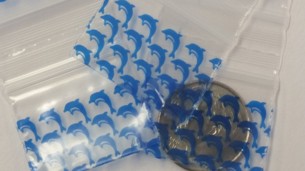 Original Apple Bags with dolphin print, 5/8" x 5/8" size, featuring colorful dolphin illustrations on clear plastic bags.