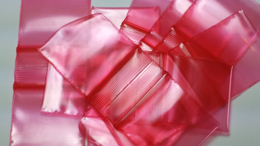 Red 5/8" x 5/8" Original Apple Bags with red twist ties, made of durable paper for packaging and gift wrapping.