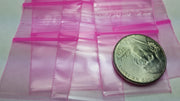 Pink 1"x1" resealable apple bags by Original Apple Bags, compact and durable for storing small items.