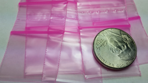 Pink 1"x1" resealable apple bags by Original Apple Bags, compact and durable for storing small items.