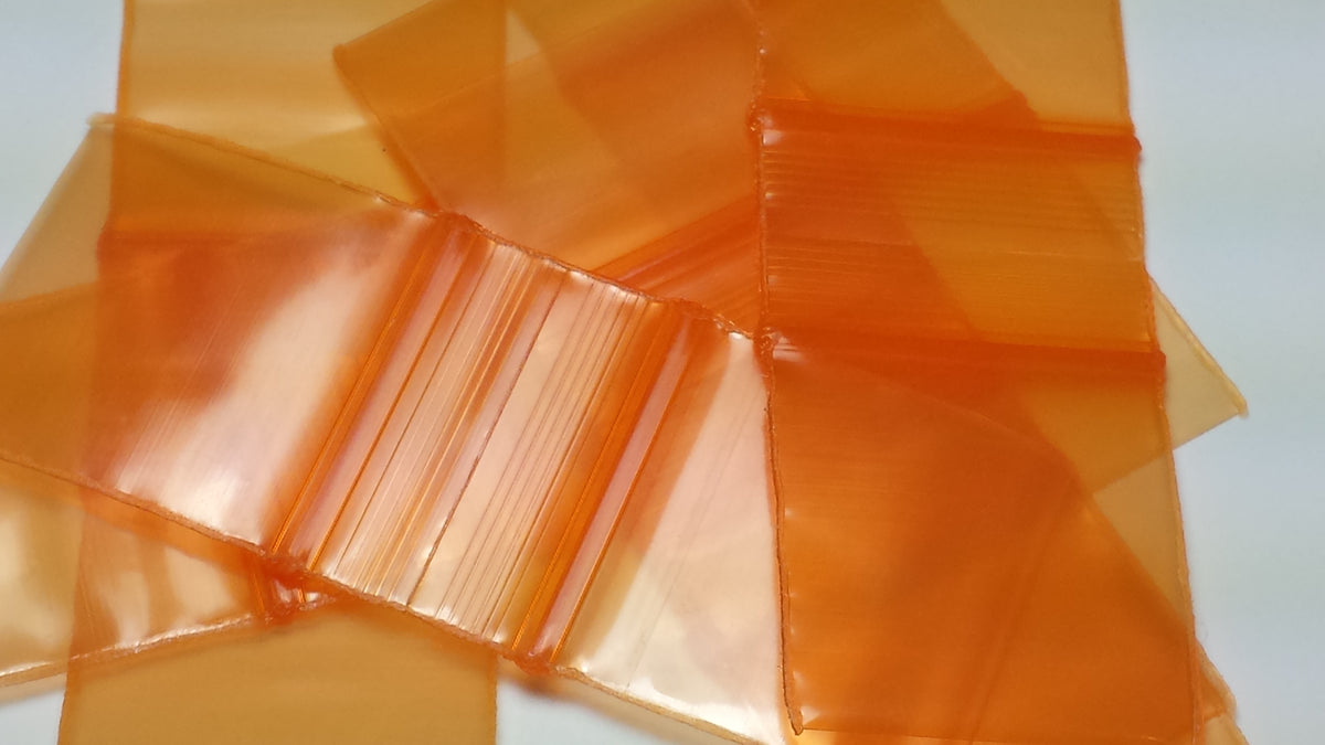 Orange Original Apple Bags measuring 5/8 inch by 5/8 inch, made from durable material, suitable for packaging small items.