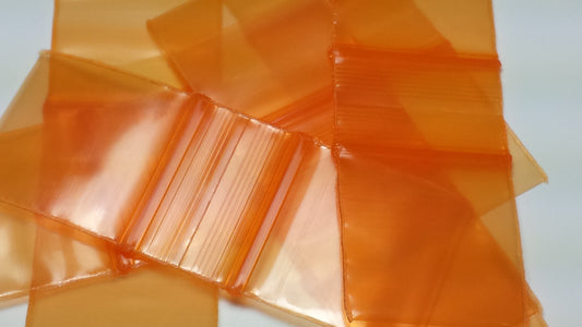 Orange Original Apple Bags measuring 5/8 inch by 5/8 inch, made from durable material, suitable for packaging small items.